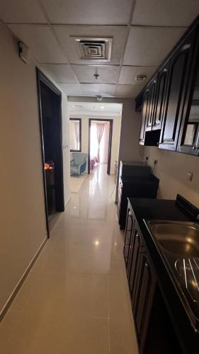 a view of a kitchen and a living room at Stunning high floor Ocean front Retreat with Panoramic Sea Views for Rent in Ras al Khaimah