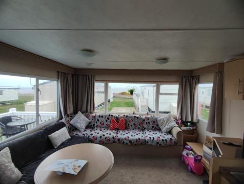 a living room with a couch and a large window at Seaview C29 in Hartlepool