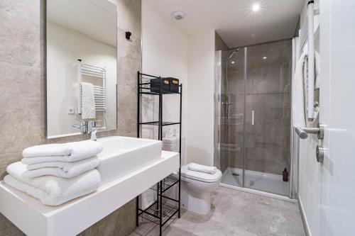 een badkamer met een wastafel, een toilet en een douche bij INF32J- Apotel Infinity by Roomservices in Estepona