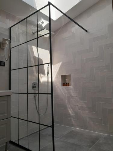 a bathroom with a shower with a glass wall at Nica Wood in Sremska Kamenica