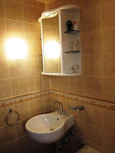 a bathroom with a sink and a mirror at House by the sea in Podaca