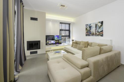 a white living room with a couch and a fireplace at Stylish 2BR flat with stunning views & prv parking in Athens