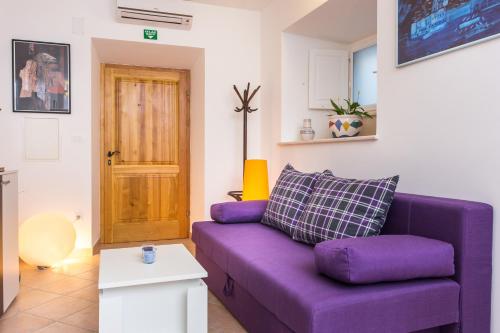 a purple couch sitting in a living room at Nila's Place in Dubrovnik