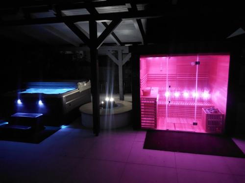 a bathroom with a hot tub and a pink lighted shower at Füge Villa Luxury & Wellness in Balatonfüred