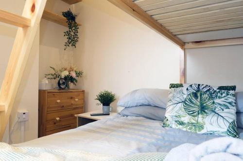 a bedroom with a bed and a dresser at LFC Stadium Apartment 2 in Liverpool