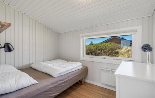 a white room with a bed and a window at 3 Bedroom Lovely Home In Hvide Sande in Bjerregård