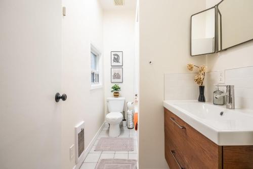 a bathroom with a sink and a toilet at Modern 1BR Condo - near Trinity Bellwoods Park in Toronto