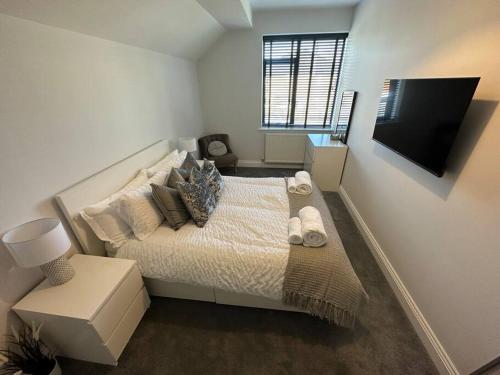 a bedroom with a large bed and a window at Brand New Luxury 2 Bedroom House in Parkstone
