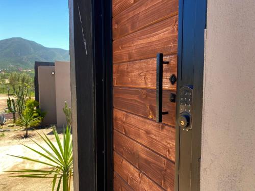 a wooden door with a view of the desert at Coquenas del Valle in Valle de Guadalupe