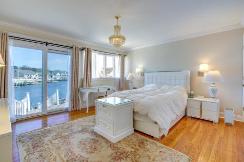 a bedroom with a bed and a large window at Toms River Vacation Rental with On-Site Dock! in Toms River