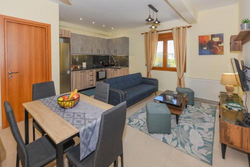 a living room with a table and a blue couch at Sea Salt Village House in Samos