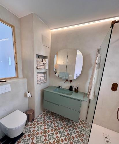 a bathroom with a sink and a toilet and a mirror at Casa Kai Altea - Torre de Bellaguarda in Altea