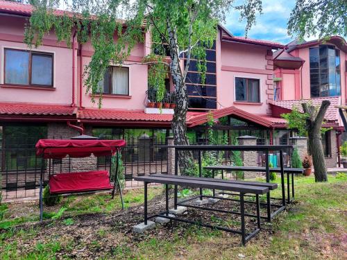 una mesa de picnic y un banco frente a un edificio en Glory en Truskavets