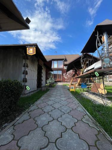 a stone walkway in front of a building at Cottage 'Carolina' with hot tub, sauna and BBQ area in Kosiv