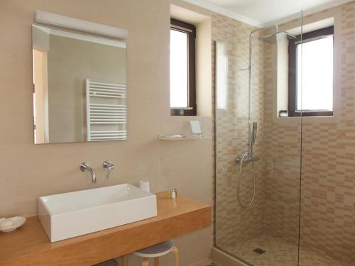 a bathroom with a sink and a glass shower at Stone Villa Analisa, Pool, BBQ, Sunset Sea view in Kondomárion