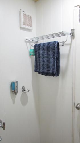 a bathroom with a towel hanging on a wall at The Laughing Woods AC Resort in Kotagiri