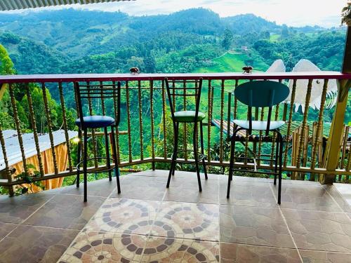 a balcony with two chairs and a table with a view at El eden in Manizales