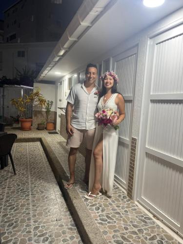 a man and a woman standing in front of a garage at Villa San Miguel in San Andrés