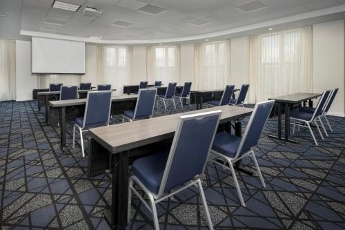 a conference room with tables and chairs and a whiteboard at Courtyard by Marriott Seattle Kirkland in Kirkland