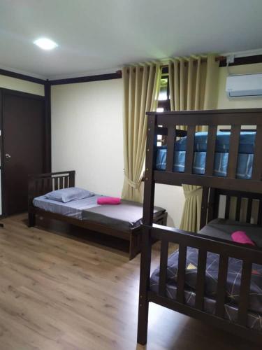 a room with two bunk beds and a window at Teratak Bayu STC in Kuala Terengganu