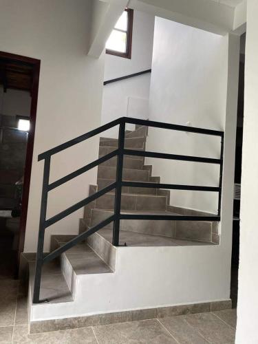 a staircase with a metal railing in a building at Villa Paulina in Guadalupe