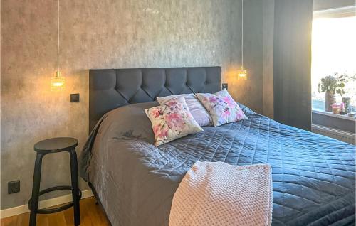 a bedroom with a bed with pillows on it at Beautiful Home In Bohus-bjrk With Wifi in Skarvik