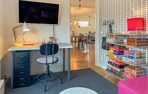 a room with a desk with a chair and books at 7 Bedroom Gorgeous Home In Bohus-Björkö in Skarvik