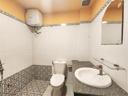 a bathroom with a toilet and a sink at iHome Hoi An in Hoi An