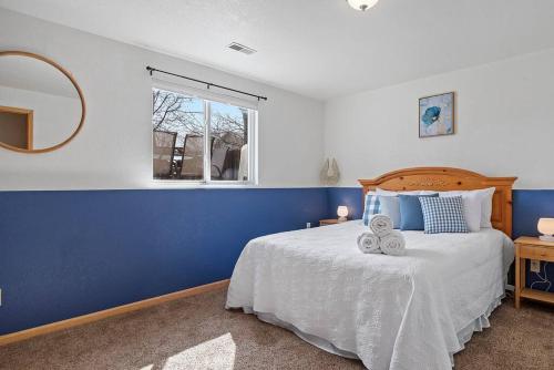 a blue and white bedroom with a bed and a mirror at Stylish 5 BR- LG Fenced Backyard and Playground in Summerset