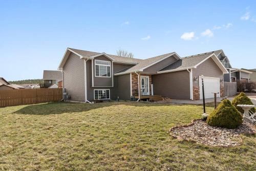 a house with a yard with a fence at Stylish 5 BR- LG Fenced Backyard and Playground in Summerset