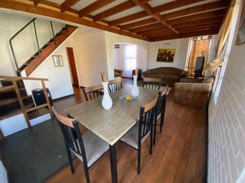 una sala de estar con una mesa de madera con jarrones. en Casa en sector residencial, en Arauco