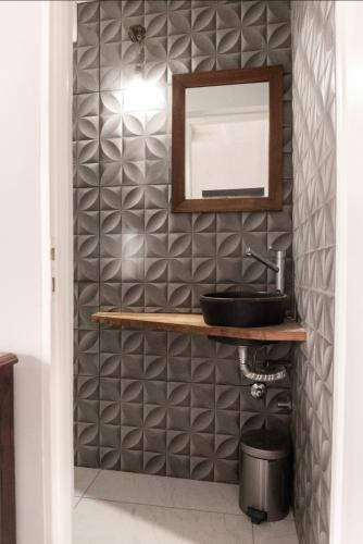 a bathroom with a mirror and a sink at Monica’s Apartments in Canning