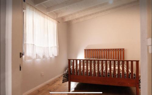 a crib in a room with a window at Monica’s Apartments in Canning