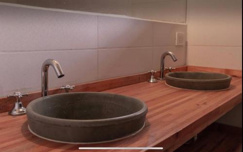 two sinks in a bathroom with two faucets at Monica’s Apartments in Canning