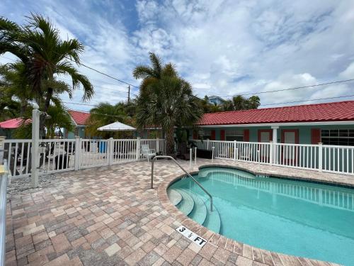 a swimming pool in front of a house at Blue Waters Treasure Island in Treasure Island