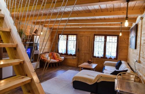 a living room with a swing in a log cabin at Chalet Mediterraneo in Ulcinj