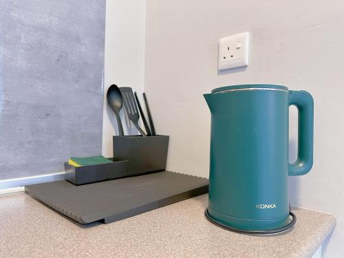 a blue vase sitting on a counter next to a box at JESSELTON QUAY SEAVIEW Can Request LateCheckout 2pm in Kota Kinabalu