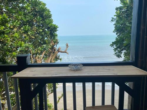 a balcony with a view of the beach at ocean view studio room by hello beach in Sukarame
