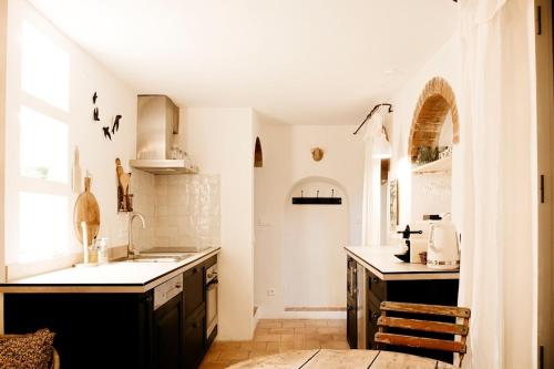 a kitchen with a sink and a counter top at La petite maison in Lourmarin