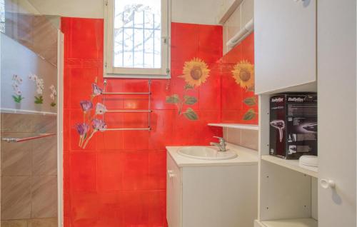 a red bathroom with a toilet and a sink at Beautiful Apartment In Le Luc With 1 Bedrooms, Wifi And Outdoor Swimming Pool in Le Luc