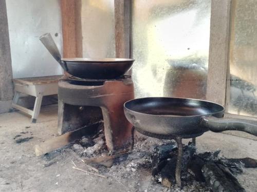 a kitchen with a bowl and a pan on a stove at Homestead Farm Payag/Bahay Kubo in Santander