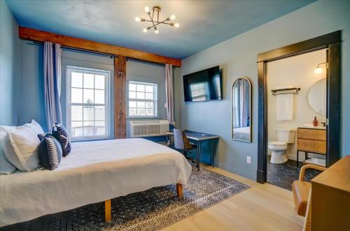 a bedroom with a bed and a bathroom at 202 - Single Queen in Waunakee