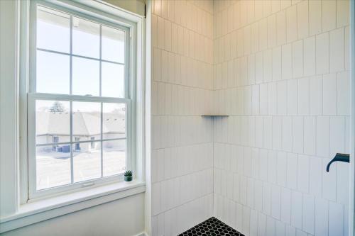 a bathroom with a shower with a window at 202 - Single Queen in Waunakee