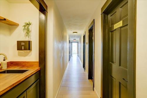 a hallway leading into a room with a door at 203 - Double Queen in Waunakee