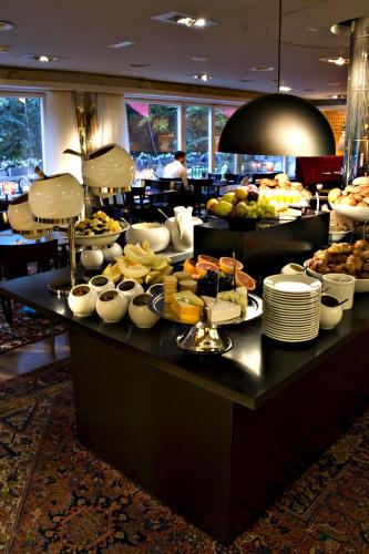 a buffet of food on a table in a restaurant at Hotel Rival in Stockholm