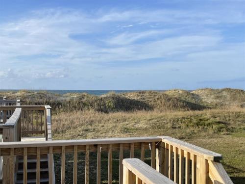 a wooden deck with a view of the beach at NC 12 56821-7 Condo in Hatteras