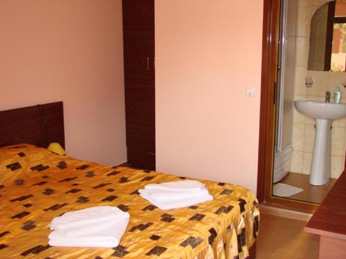 a bedroom with a bed with two towels on it at Casa Elisabeta Constanta in Constanţa