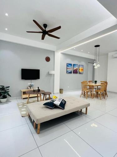 a living room with a couch and a ceiling fan at Inn Homestay in Teluk Intan