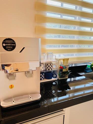 a kitchen with a counter top with aifts at Inn Homestay in Teluk Intan