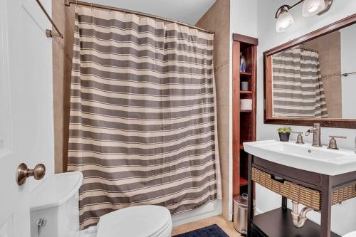 a bathroom with a sink and a shower curtain at Private Single Family Home Close to Both Water and Downtown! in Annapolis